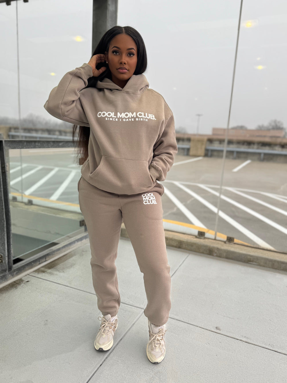 Cool Mom Club Hoodie & Sweats Set in Nude color worn by a black model standing outside